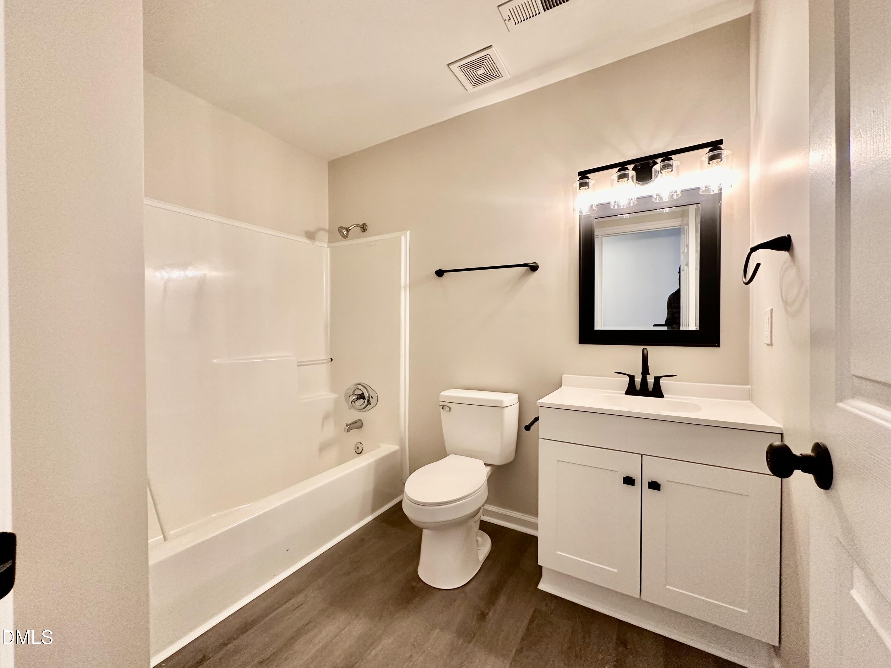 420 Tippett Road Zebulon, NC 27597 - Photo 8 of 14 a bathroom with a toilet sink and mirror
