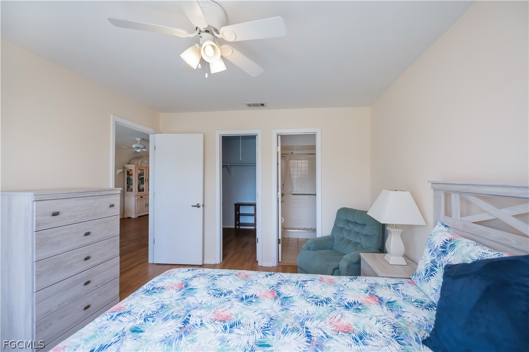 1100 Pondella Road, Unit 514 Cape Coral, FL 33909 - Photo 16 of 34 a bedroom with a bed and a dresser in it