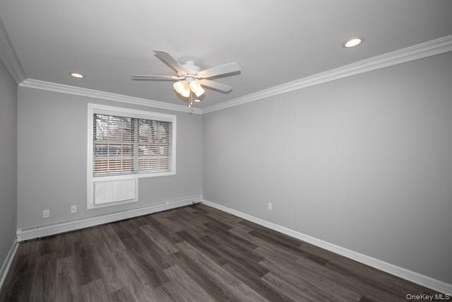 7 Spinning Wheel Road, Unit 1B Massapequa, NY 11758 - Photo 6 of 12 an empty room with wooden floor and windows