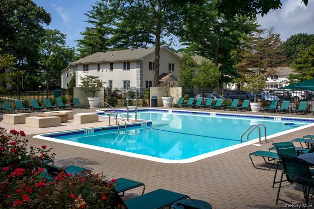 7 Spinning Wheel Road, Unit 1B Massapequa, NY 11758 - Photo 9 of 12 a view of a house with swimming pool and sitting area