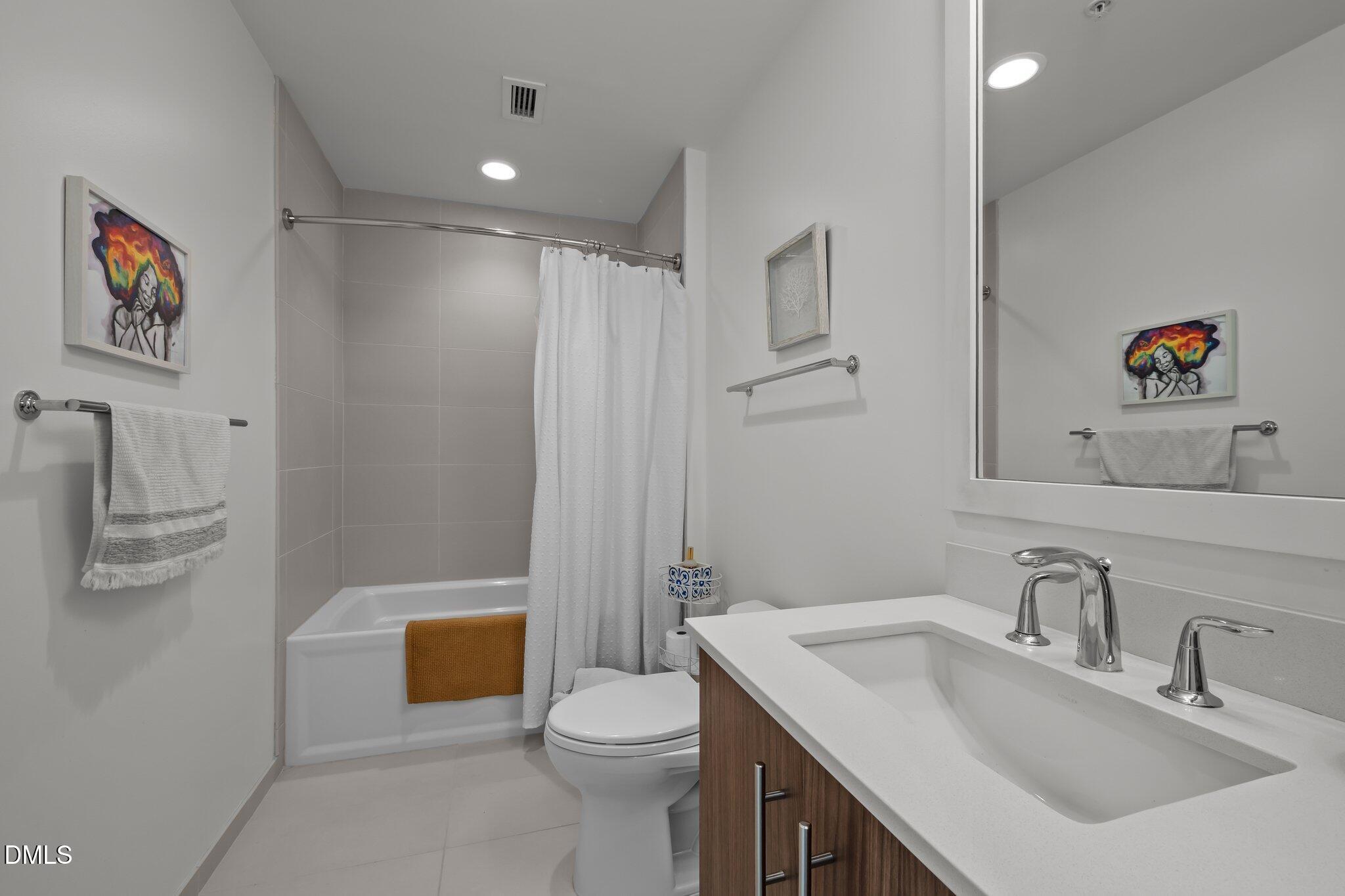 110 Corcoran Street, Unit 2101 Durham, NC 27701 - Photo 13 of 23 a bathroom with a sink a toilet and shower