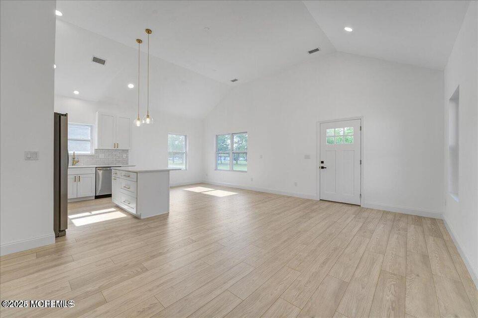 553 Ocean Gate Drive Ocean Gate, NJ 08740 - Photo 4 of 25 an empty room with wooden floor and windows