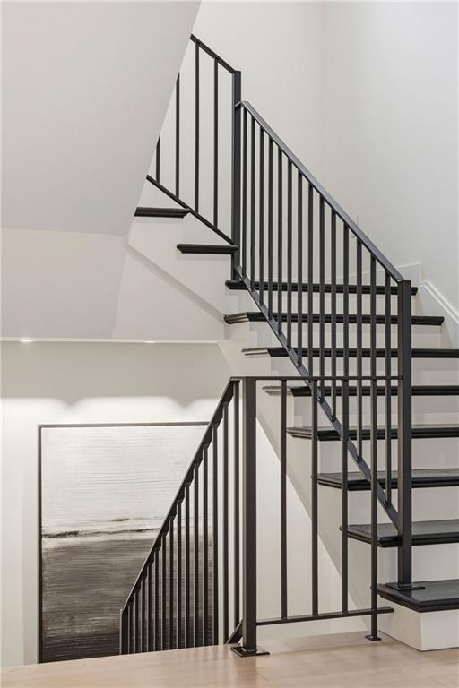 810 Persimmon Road Sewickley, PA 15143 - Photo 23 of 49 The sculptural open staircase — dark oak treads, white risers, and a custom blackened steel balustrade — is genuinely beautiful from every angle and connects all three levels of the home.