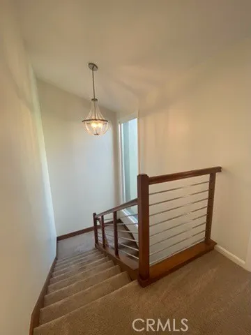 a view of a hallway with entryway wooden floor and front door