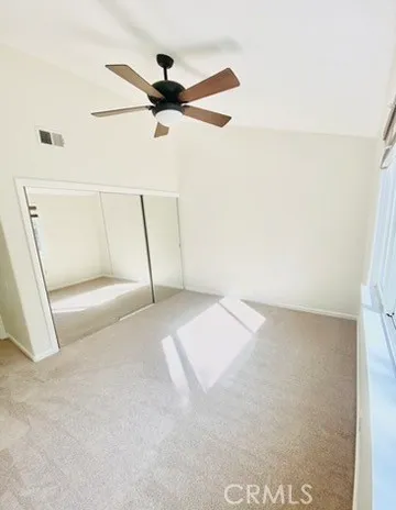 a view of a room with a ceiling fan