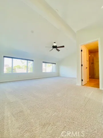 an empty room with windows and closet