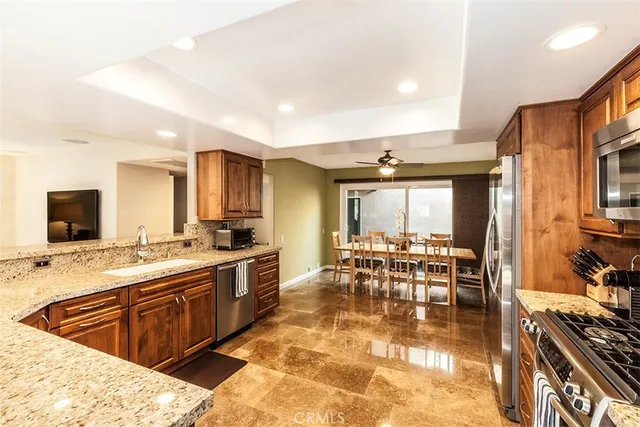 a large kitchen with lots of counter top space and stainless steel appliances