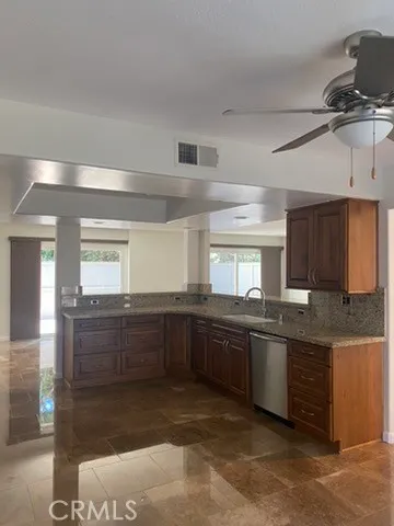 a kitchen with granite countertop a sink and cabinets