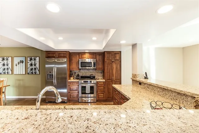 a living room with furniture a flat screen tv and floor to ceiling window