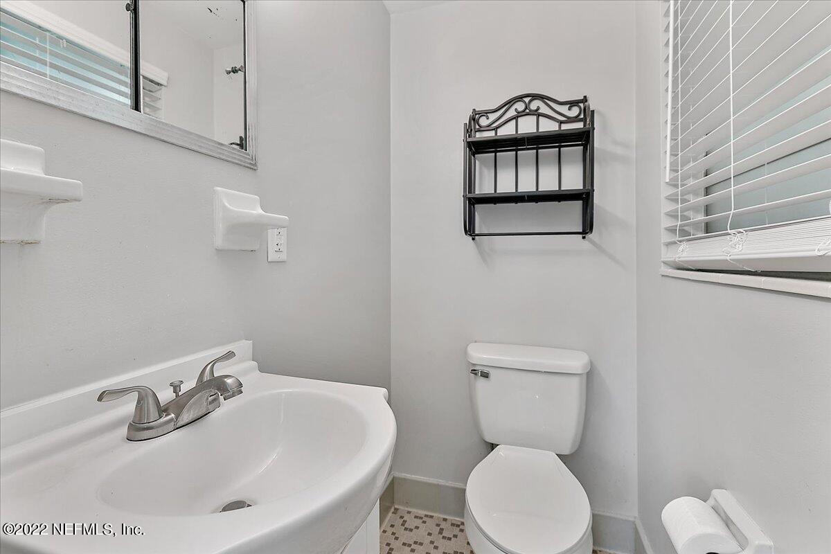 5848 Ensenada Road Jacksonville, FL 32244 - Photo 8 of 18 a bathroom with a toilet a sink and mirror