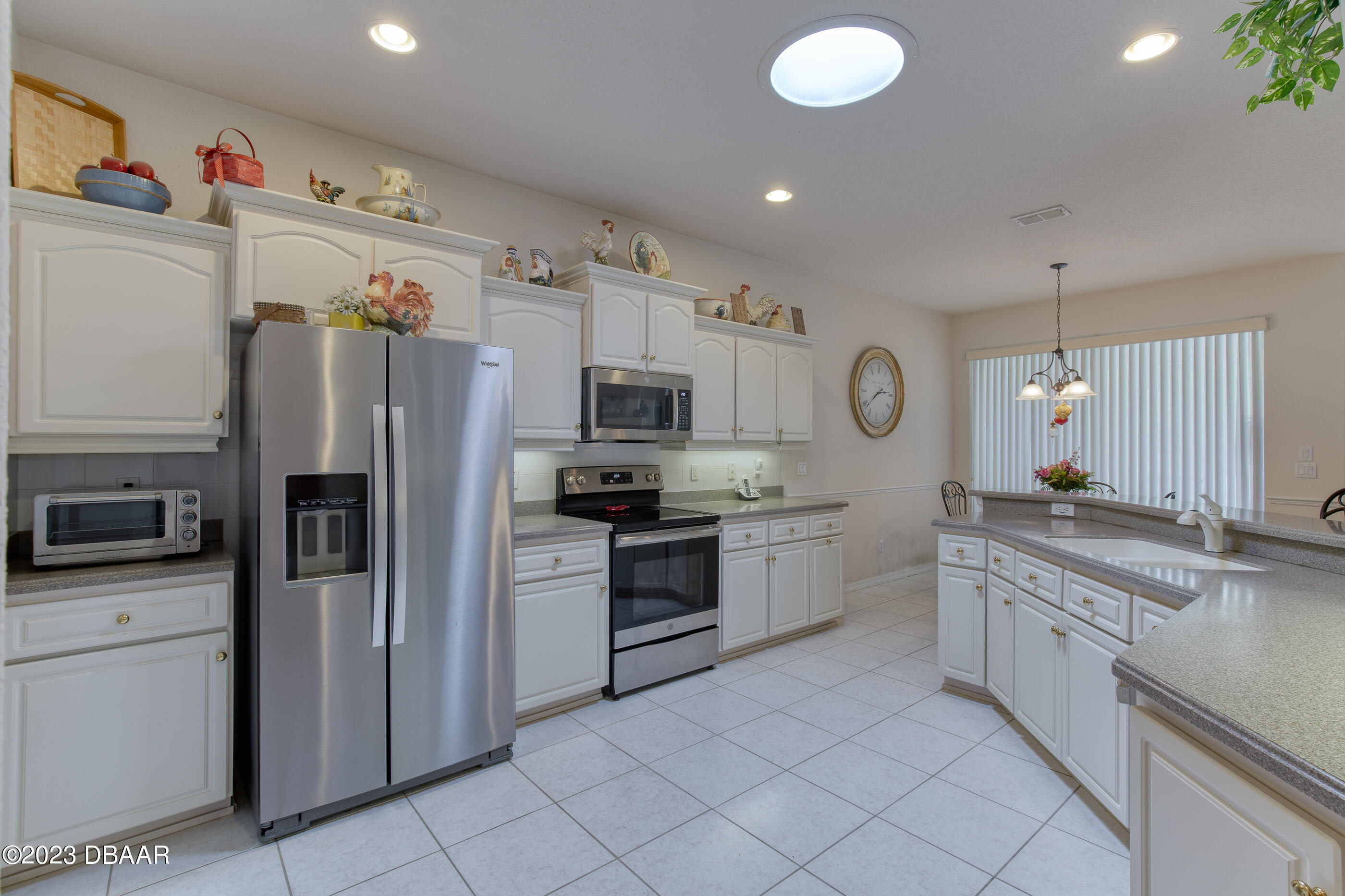 87 Timucuan Drive Ormond Beach, FL 32174 - Photo 13 of 63 a kitchen with granite countertop cabinets and stainless steel appliances