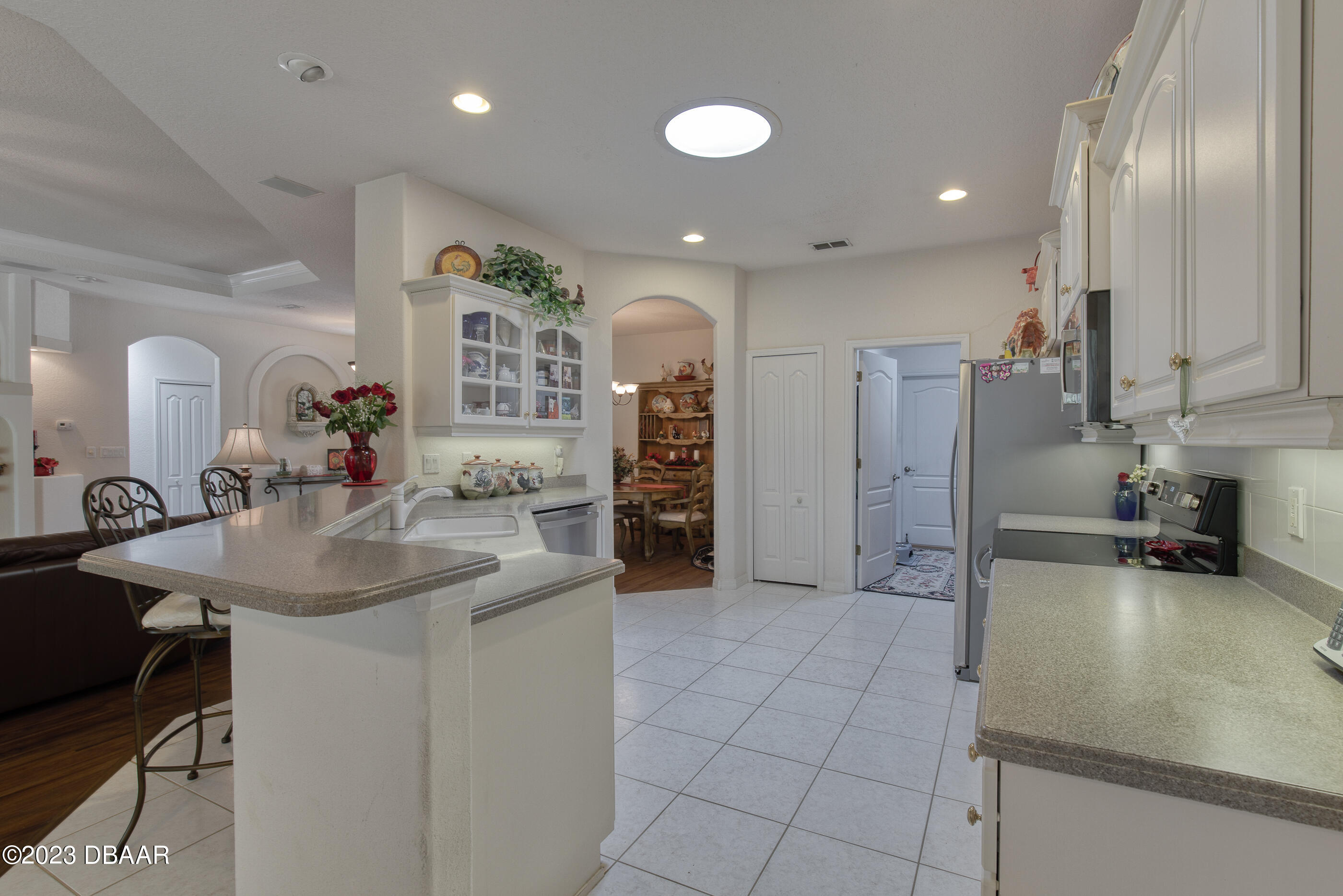 87 Timucuan Drive Ormond Beach, FL 32174 - Photo 15 of 63 a kitchen with stainless steel appliances granite countertop a sink and a refrigerator