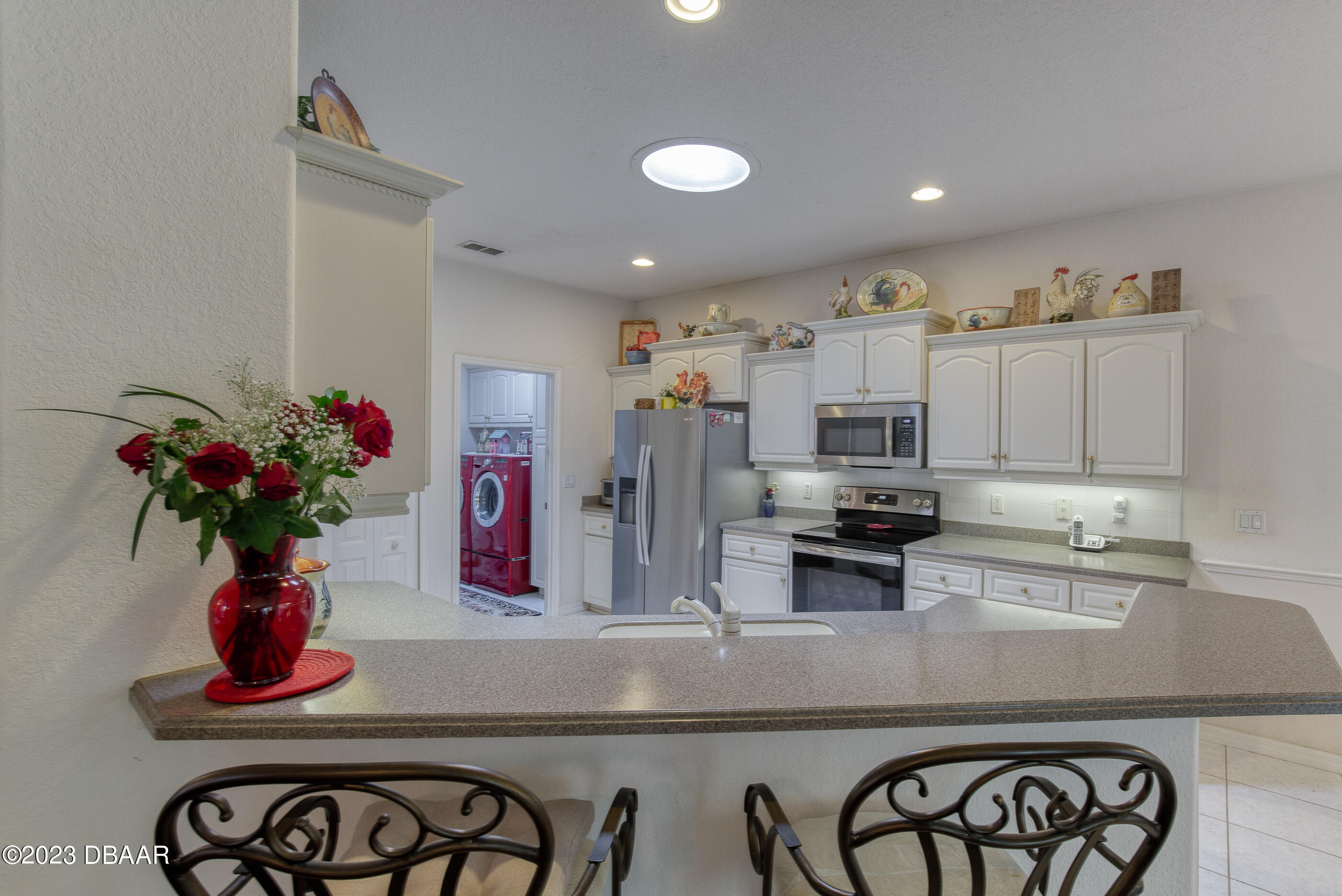 87 Timucuan Drive Ormond Beach, FL 32174 - Photo 16 of 63 a kitchen with stainless steel appliances granite countertop a refrigerator a stove and a sink