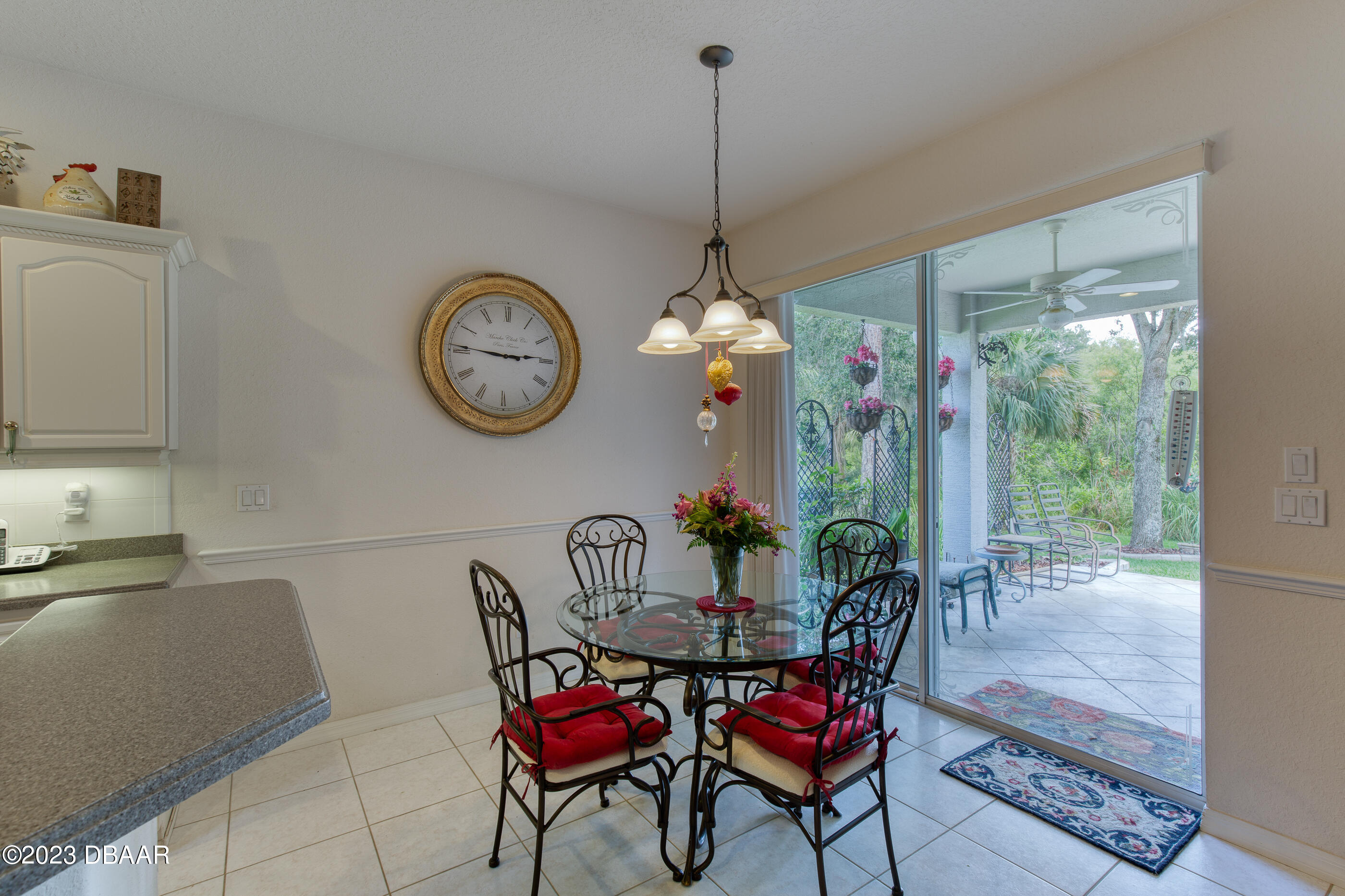 87 Timucuan Drive Ormond Beach, FL 32174 - Photo 18 of 63 a dining room with furniture a chandelier and a rug