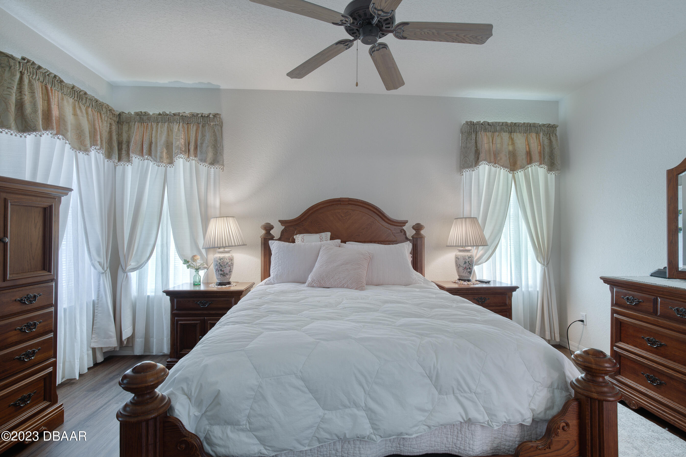 87 Timucuan Drive Ormond Beach, FL 32174 - Photo 21 of 63 a bedroom with a bed and a flat tv screen on dresser