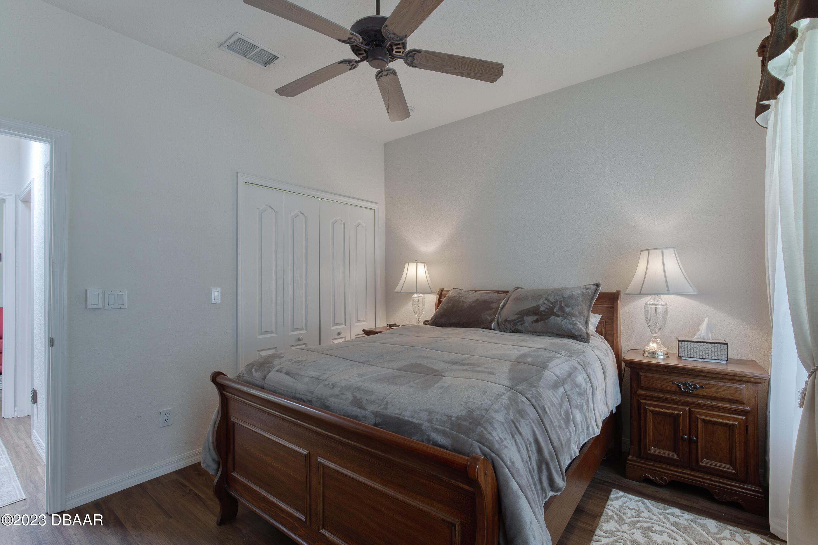 87 Timucuan Drive Ormond Beach, FL 32174 - Photo 27 of 63 a bedroom with a bed and a chandelier