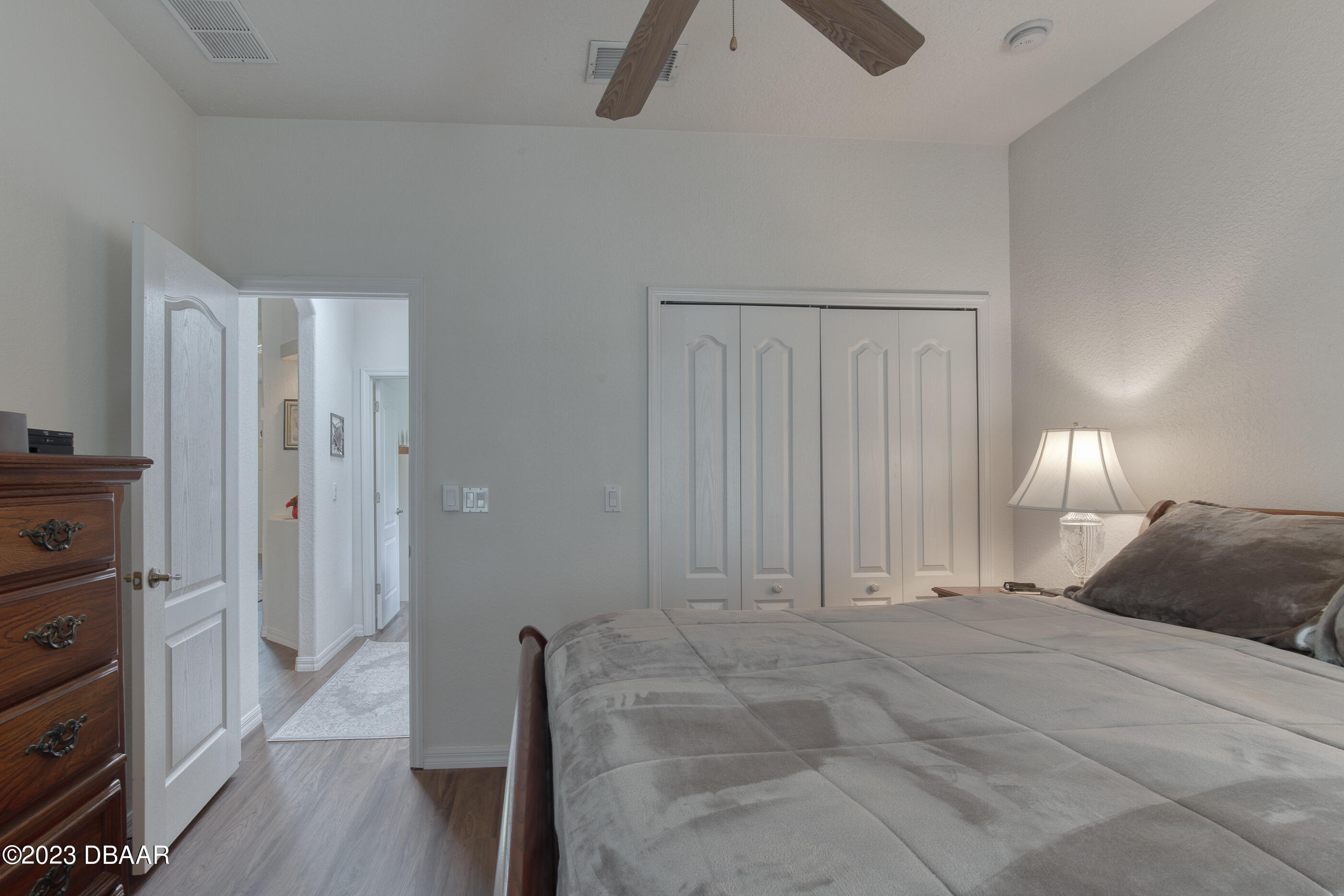 87 Timucuan Drive Ormond Beach, FL 32174 - Photo 28 of 63 a spacious bedroom with a bed and wooden floor