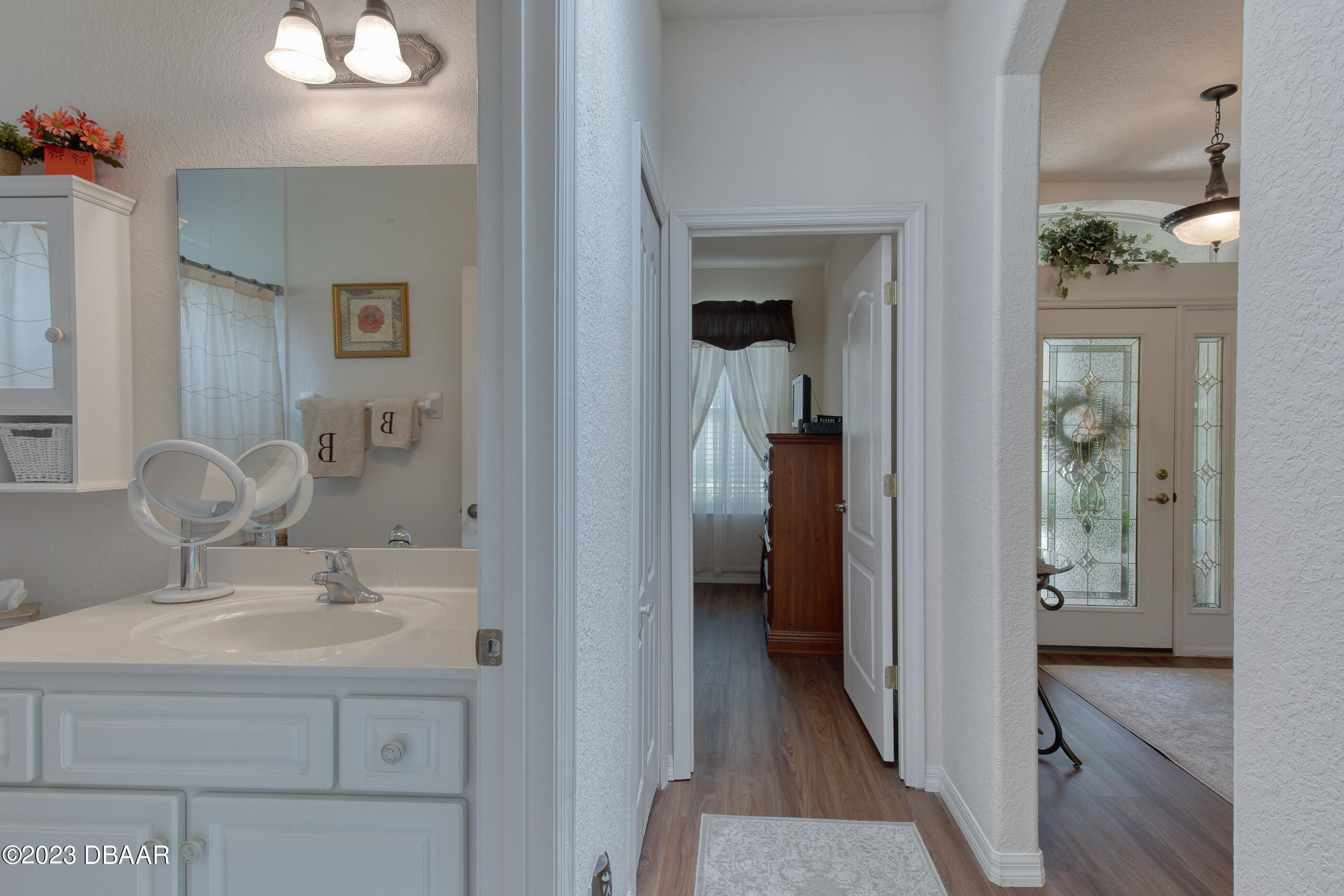87 Timucuan Drive Ormond Beach, FL 32174 - Photo 29 of 63 a en suite bathroom with a sink and a mirror