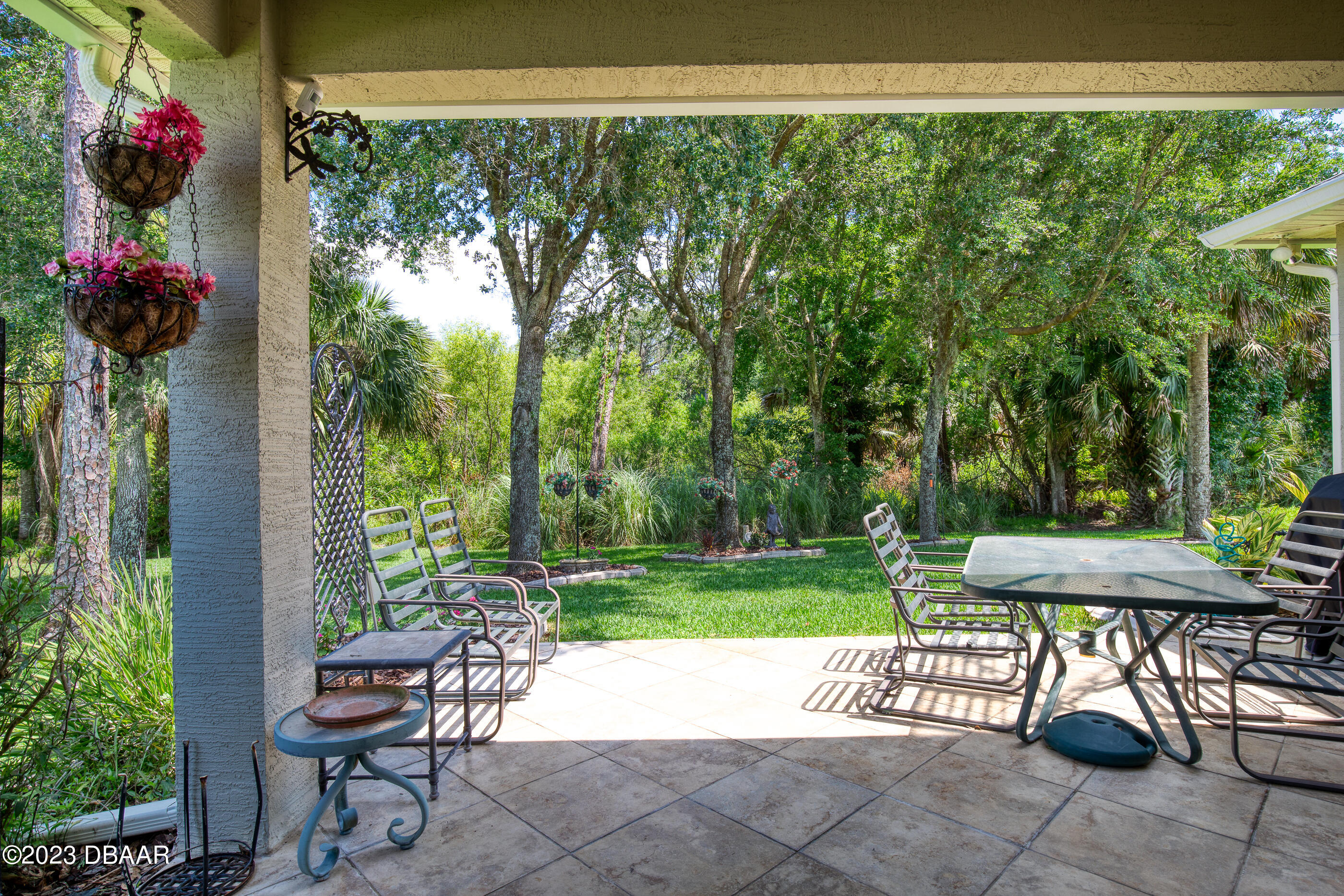 87 Timucuan Drive Ormond Beach, FL 32174 - Photo 40 of 63 a view of a table and chairs in the garden