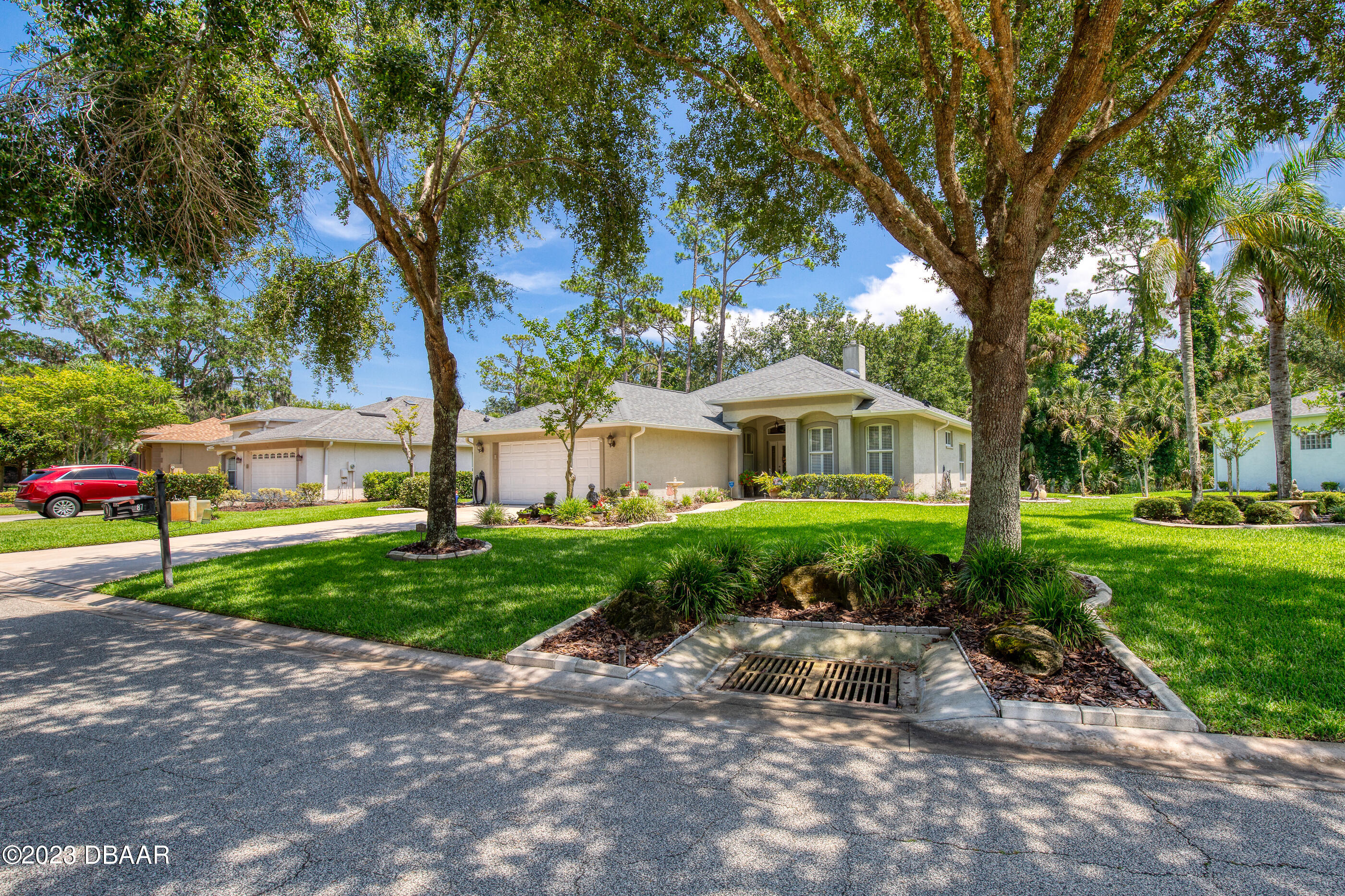 87 Timucuan Drive Ormond Beach, FL 32174 - Photo 4 of 63 a front view of a house with a yard