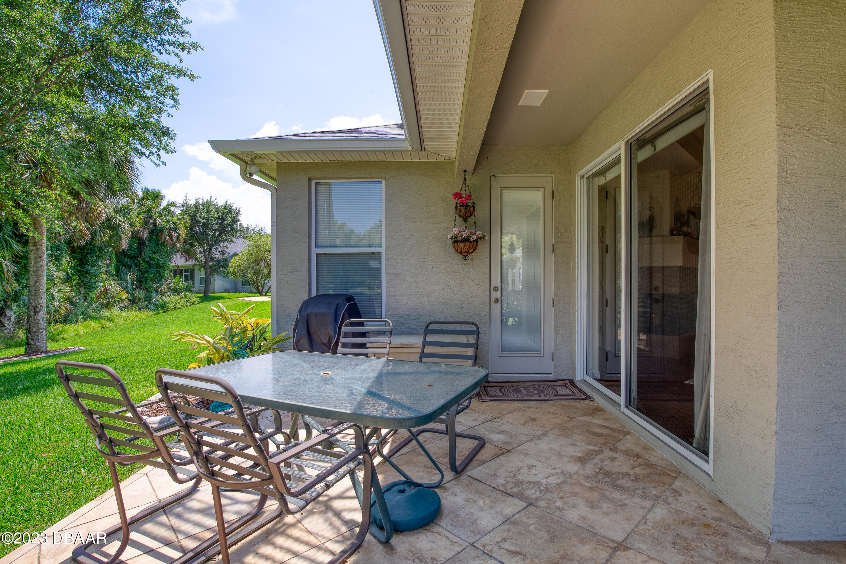 87 Timucuan Drive Ormond Beach, FL 32174 - Photo 42 of 63 a view of an outdoor dining space with a table and chairs
