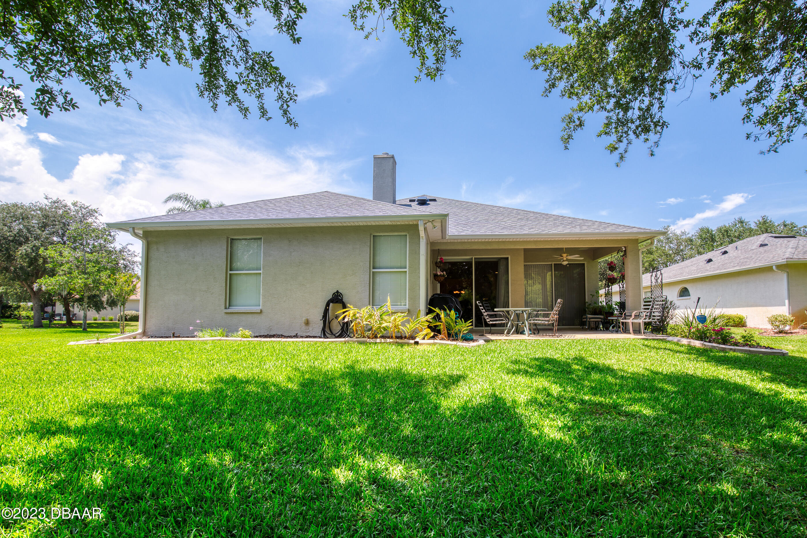 87 Timucuan Drive Ormond Beach, FL 32174 - Photo 44 of 63 a view of a house with a yard and sitting area