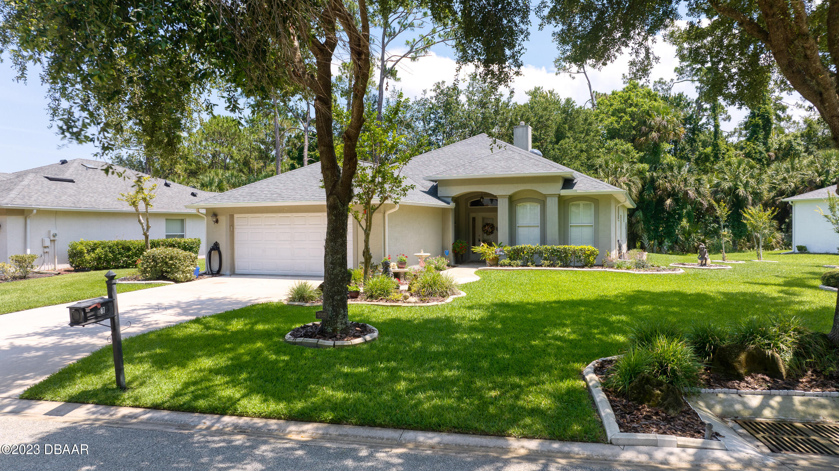 87 Timucuan Drive Ormond Beach, FL 32174 - Photo 49 of 63 a front view of a house with yard and green space