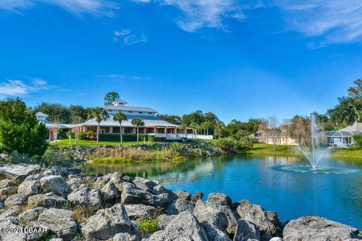 87 Timucuan Drive Ormond Beach, FL 32174 - Photo 50 of 63 a view of a lake with a house in the background