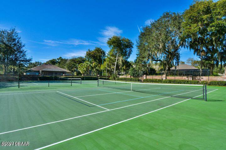 87 Timucuan Drive Ormond Beach, FL 32174 - Photo 54 of 63 a view of a tennis ground with large trees