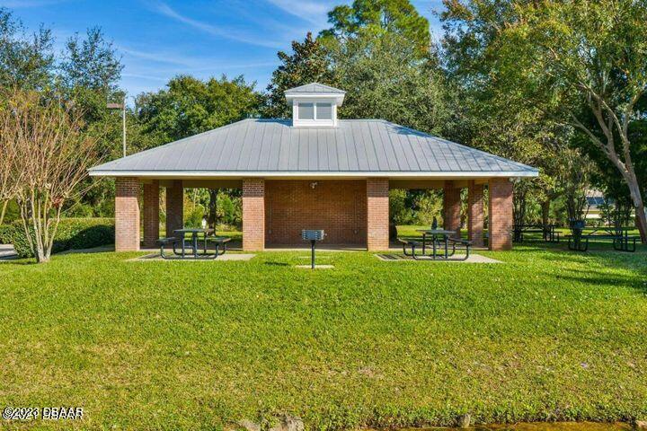 87 Timucuan Drive Ormond Beach, FL 32174 - Photo 56 of 63 a front view of house with yard and green space