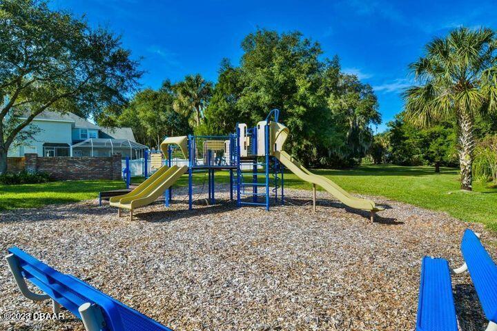 87 Timucuan Drive Ormond Beach, FL 32174 - Photo 61 of 63 a view of a park with swings