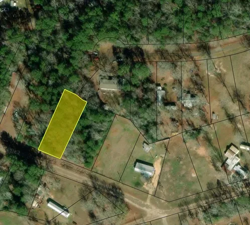 an aerial view of a residential houses with yard