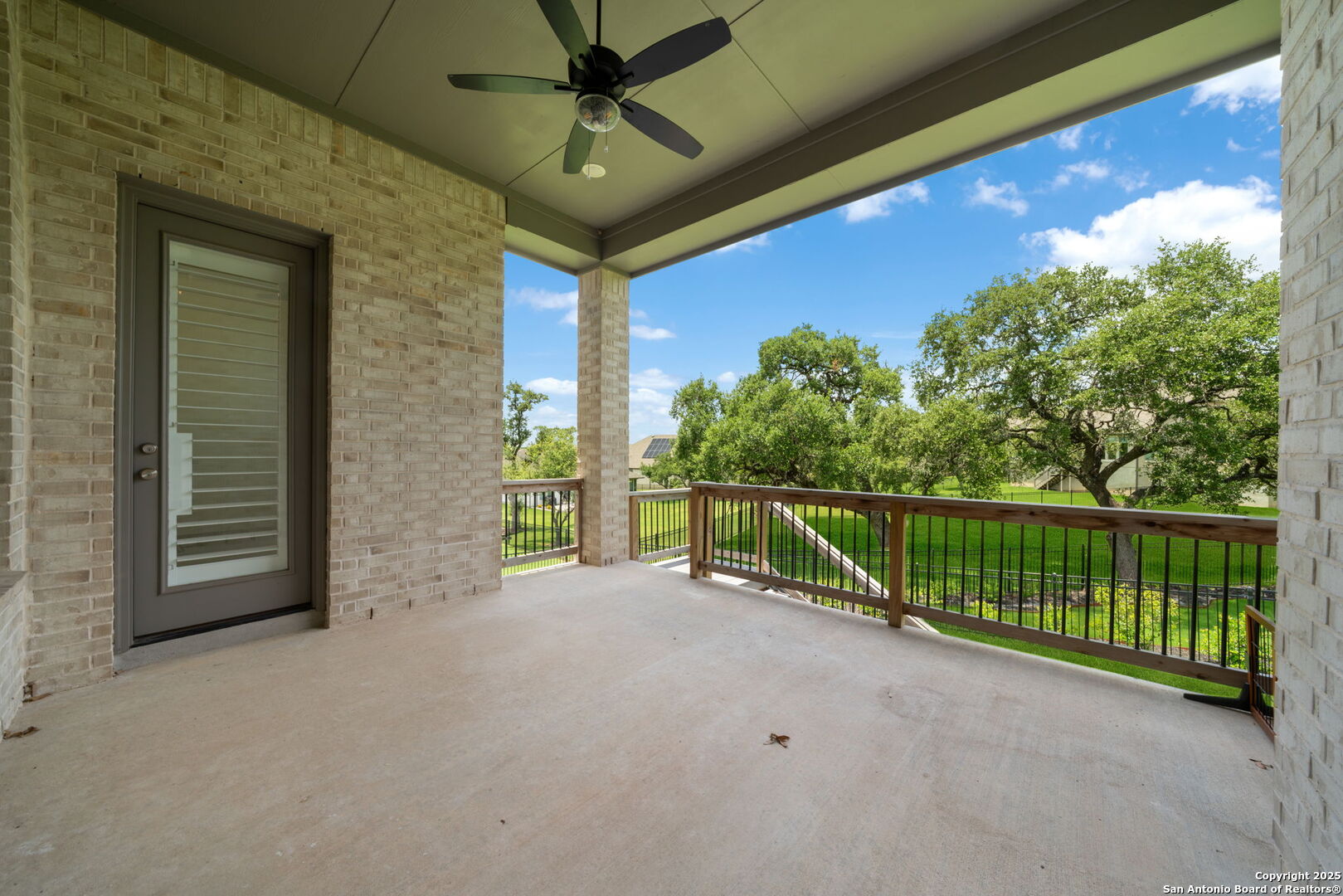 220 Corazon Boerne, TX 78006 - Photo 35 of 50 a view of a balcony with a floor to ceiling window and tree