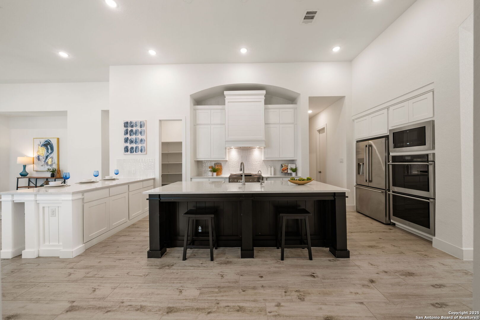 220 Corazon Boerne, TX 78006 - Photo 10 of 50 a kitchen with kitchen island stainless steel appliances a sink cabinets and wooden floor