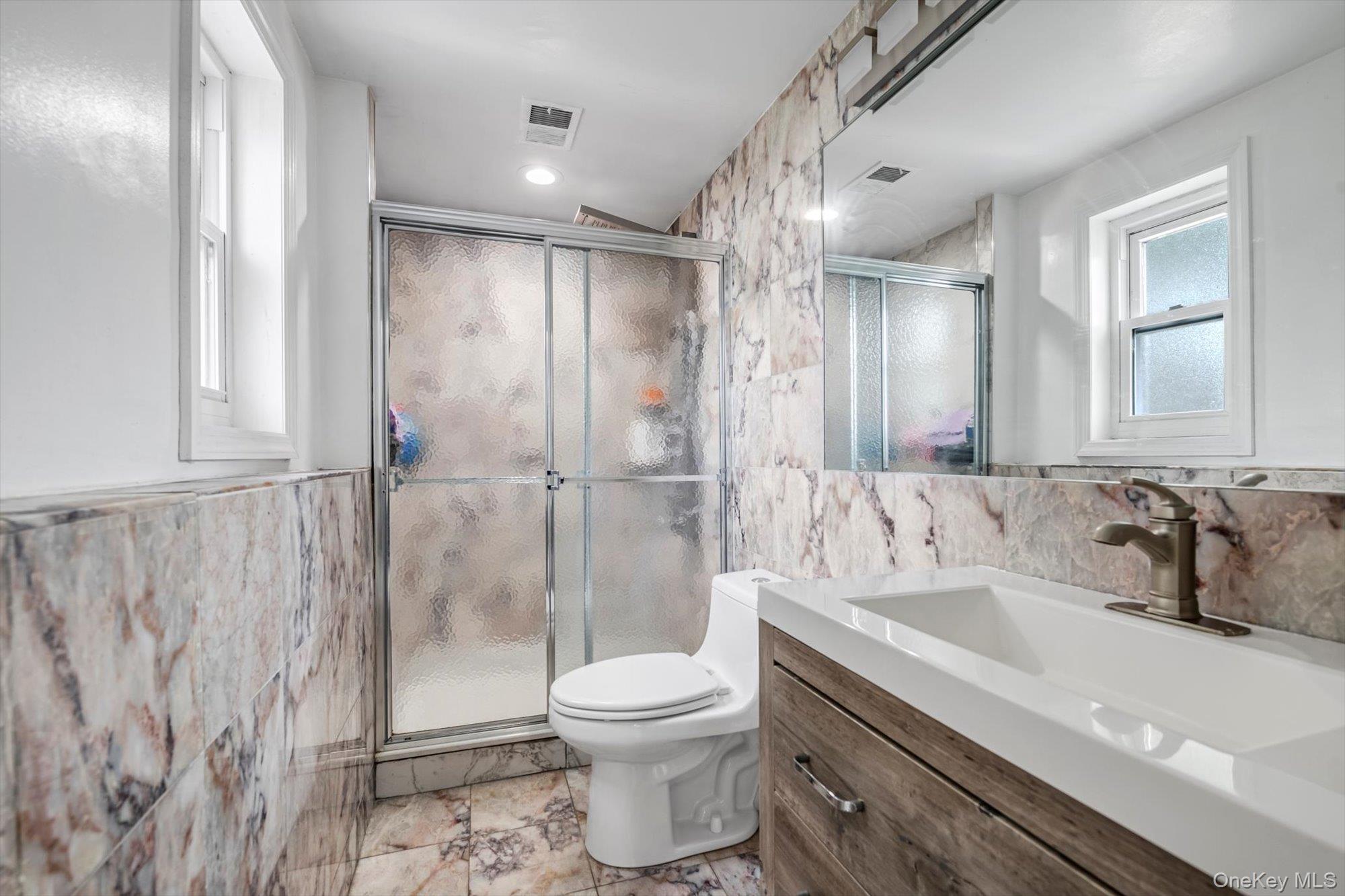 12 Julliard Drive Plainview, NY 11803 - Photo 16 of 23 Full bathroom featuring tile walls, vanity, and a shower stall