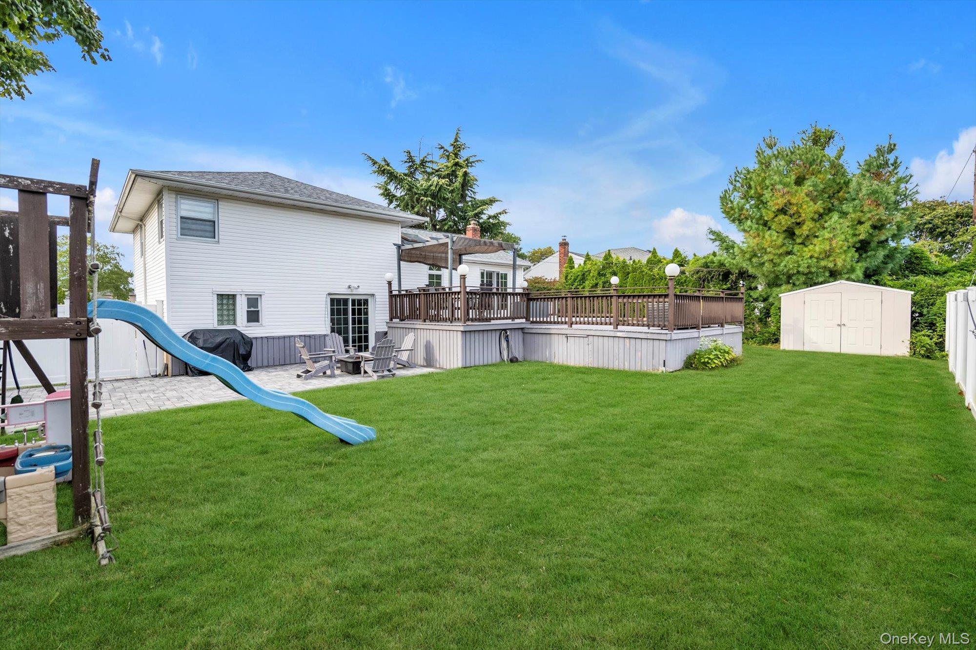 12 Julliard Drive Plainview, NY 11803 - Photo 22 of 23 View of yard with a storage shed, a patio area, and a deck