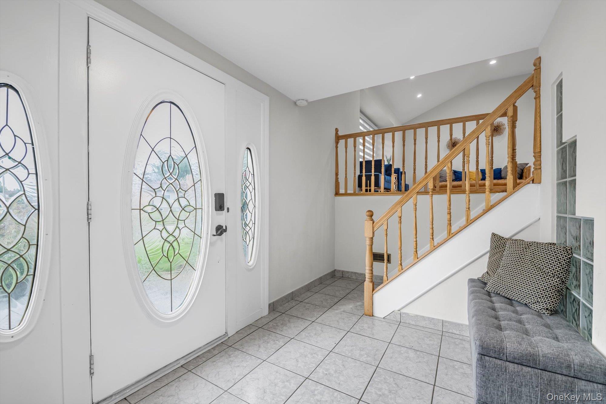 12 Julliard Drive Plainview, NY 11803 - Photo 3 of 23 Entryway featuring plenty of natural light, light tile patterned flooring, recessed lighting, and stairway