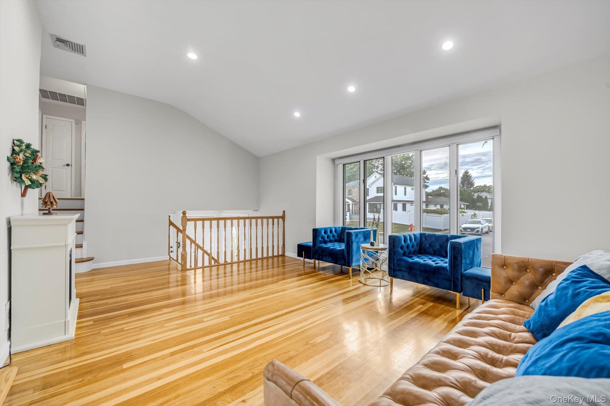 12 Julliard Drive Plainview, NY 11803 - Photo 4 of 23 Living room featuring recessed lighting, light wood-style flooring, and lofted ceiling