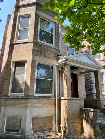 a front view of a house with large windows