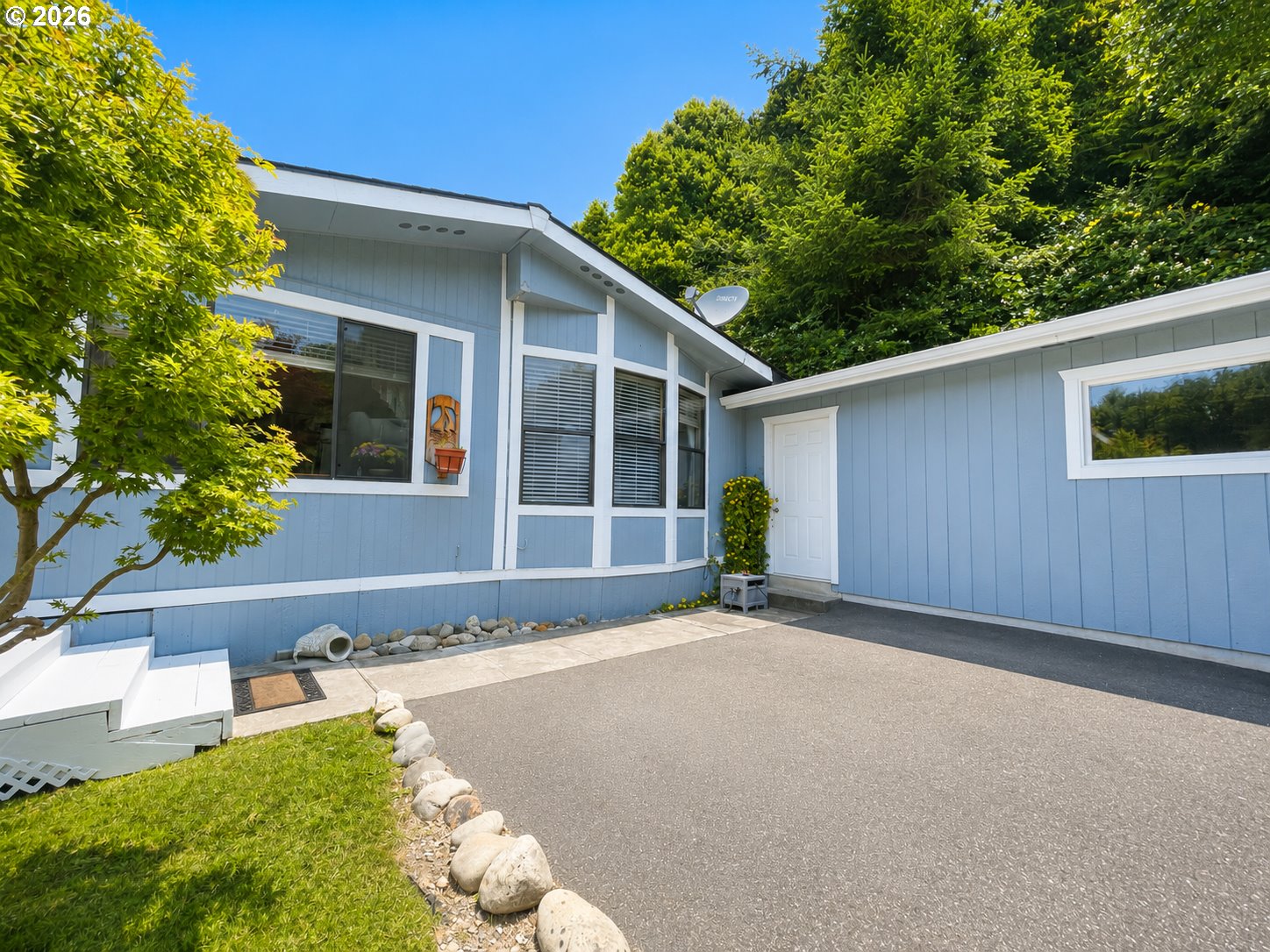 16219 Lower Harbor Road, Unit 16 Brookings, OR 97415 - Photo 1 of 40 a view of a house with a yard and potted plants