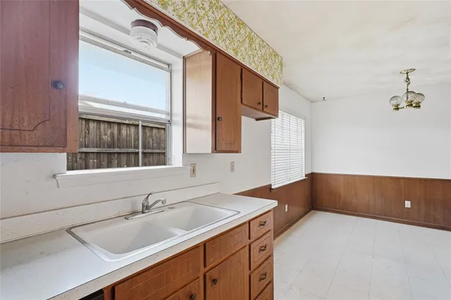 a kitchen with stainless steel appliances a sink stove and cabinets