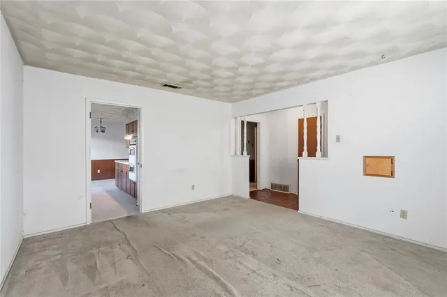 an empty room with cabinet and a window