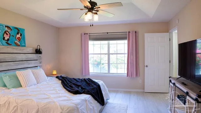 a bedroom with a bed and a flat screen tv