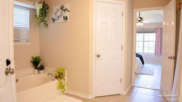 a bathroom with a tub a sink and a shower curtain