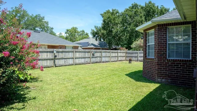 a view of backyard with garden and deck