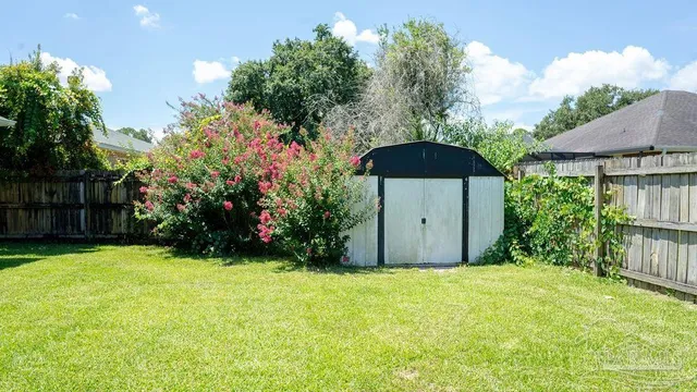 a backyard of a house with an outdoor space and trees