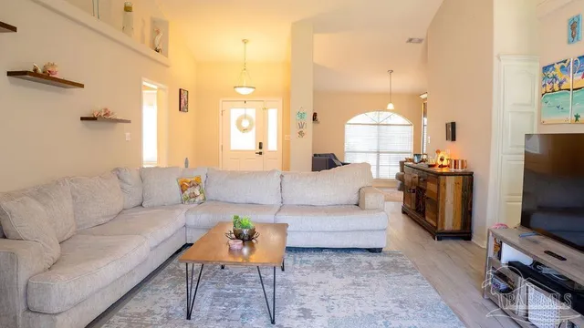 a living room with furniture and a flat screen tv