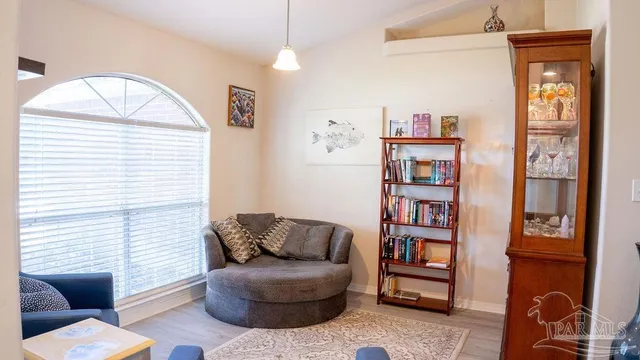 a living room with furniture a rug and a window