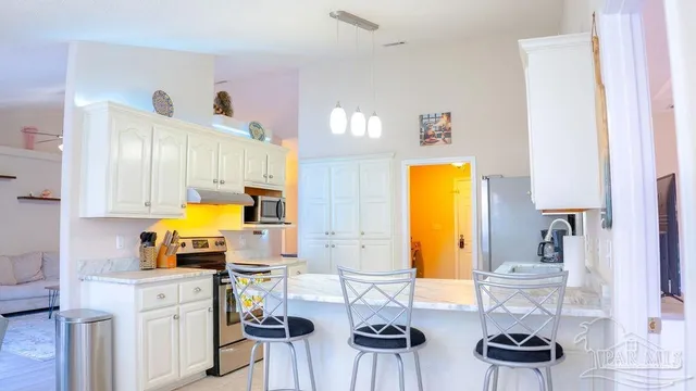 a view of living room with granite countertop furniture and a fireplace