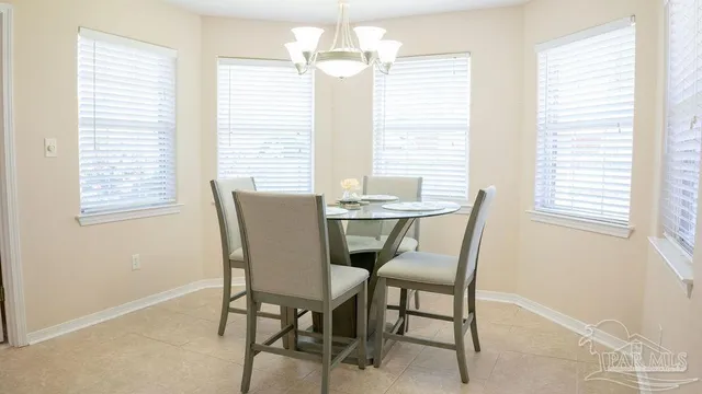 a dining room with furniture and window